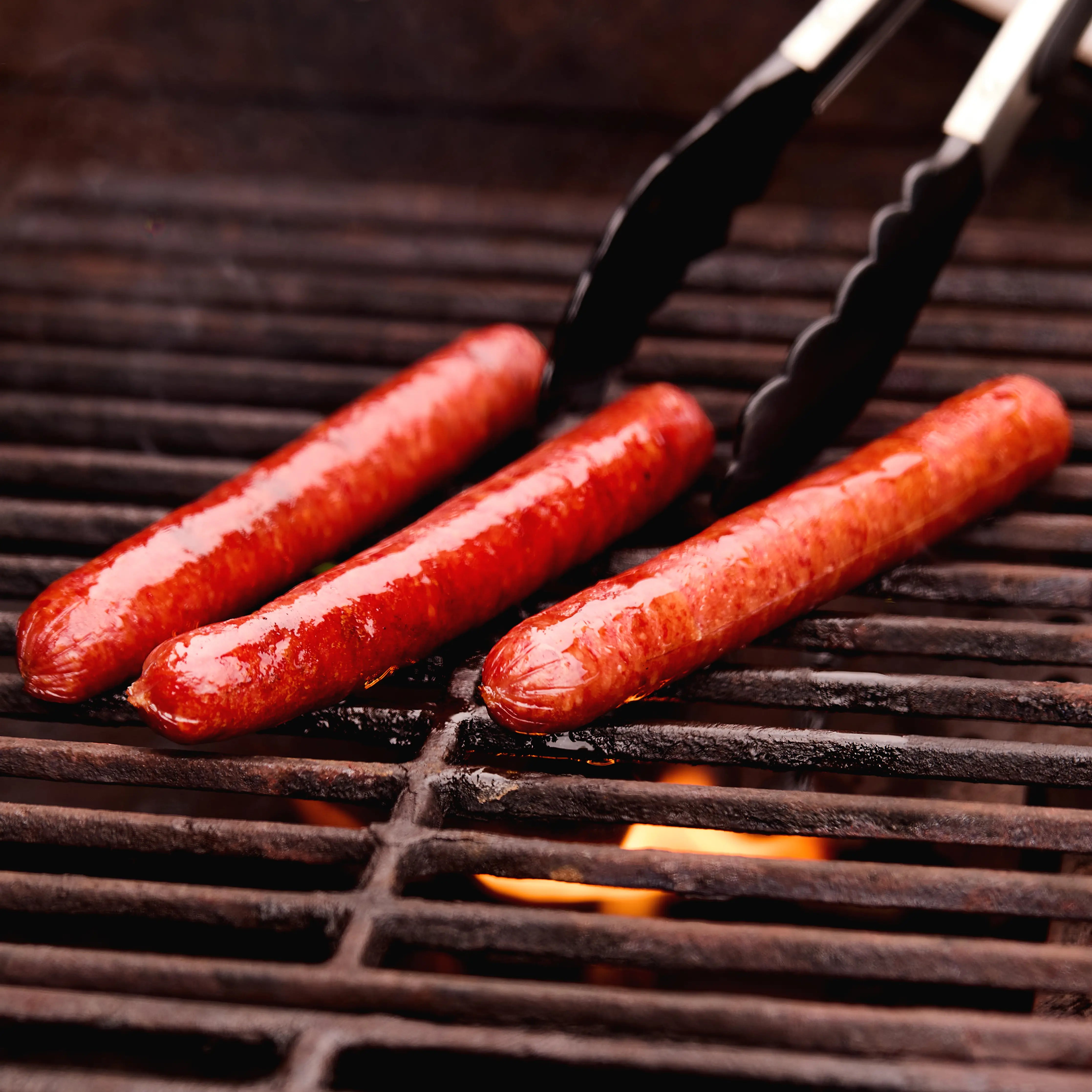 Beretta Beef Brisket Hot Dogs cooking on a grill
