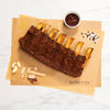 Rack of ribs with a side of sauce 
