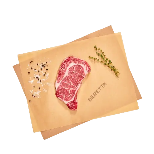 Organic Beef Ribeye Steak on brown paper